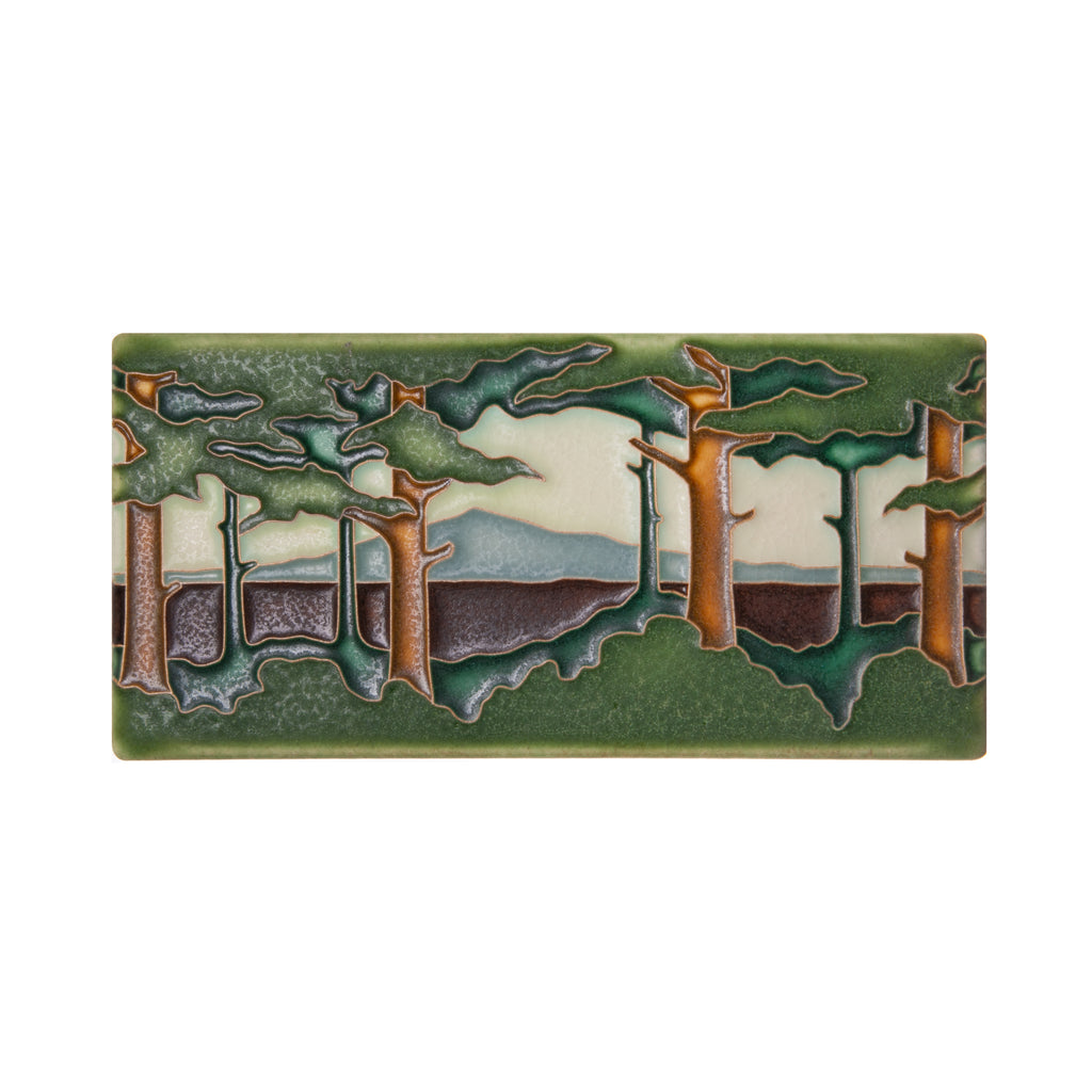 This horizontal Pine Landscape ceramic tile is handcrafted and inspired by Arts and Crafts movement. Adapted from Grueby Faience designer Addison LeBoutillier's tile "Pines." Motawi signature polychrome. Size: Approximately 3 7/8” x 7 7/8". Notch at the back for hanging. Tile stand sold separately.