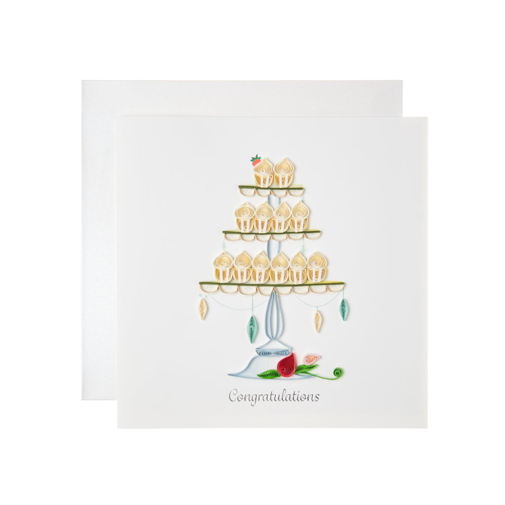 The only thing better than a wedding cake is a wedding cupcake tower! This design is perfect for you to congratulate any couple on their big day. This quilled congratulations card includes a three-tier stand with cream and white colored cupcakes Outside Copy: Congratulations Inside Copy: Blank.