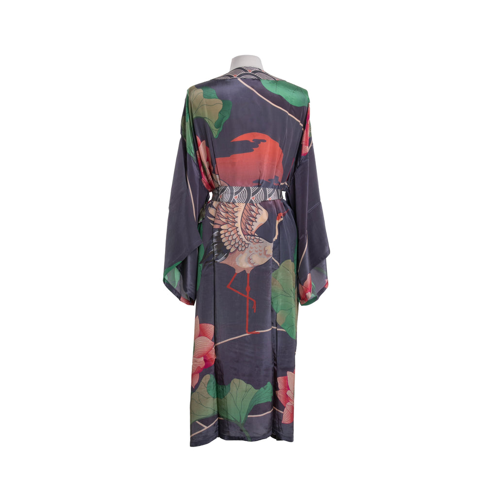 This stunning short-length kimono jacket features a large, majestic crane standing amid oversized greenery at sunset. The kimono features a flattering back neckline, side slits that allow for movement, and wide sleeves—all of which make it a breeze to wear casually or dress up for a formal event. One size fits most.