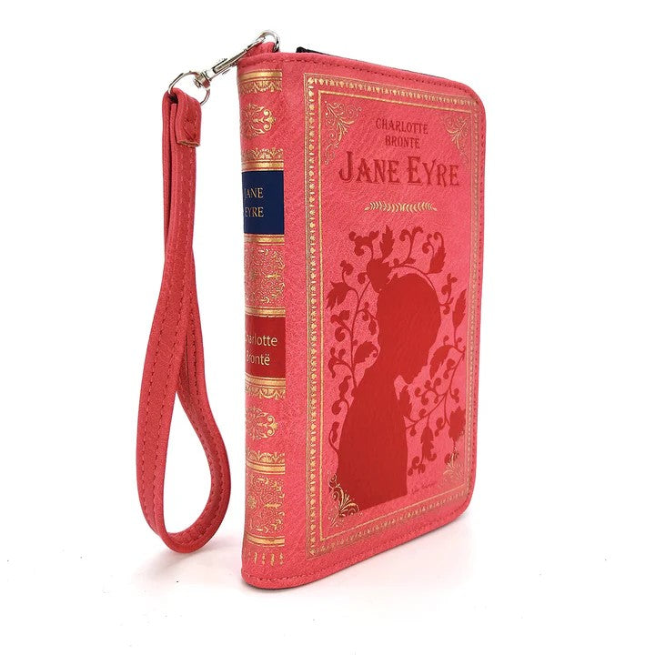 Live your best Victorian-era life with this wallet inspired by literature classic Jane Eyre by Charlotte Brontë. In pink, gold, and red for maximum style. Wallet has 9 card slots and an ID card window as well as a button clasp closure and a wristlet drop of 8". Dimensions: Approx. 4.5" x 1.5"x 7" Material: Vinyl