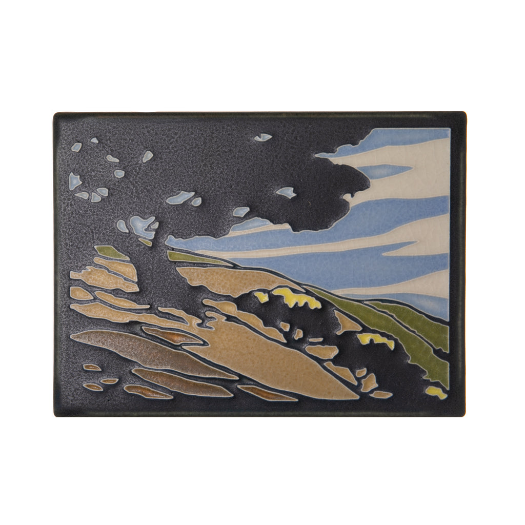 Artist Yoshiko Yamamoto is a self-taught block printmaker who fuses Japanese design sensibility with fine craftsmanship. "California Oak" tile is inspired by the rolling hills of the Central Coast in California. 5 7/8” x 7 7/8”. Motawi tiles are handcrafted. Notch at the back for hanging. Tile stand sold separately.