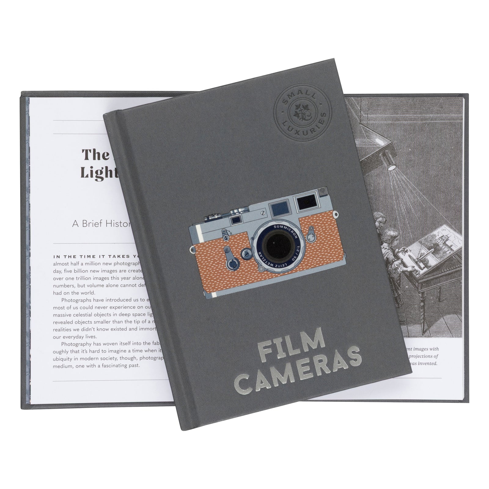 A dark gray hardcover book titled 'Film Cameras' with a vintage camera illustration on the cover, displayed over an open printed booklet on a white background.