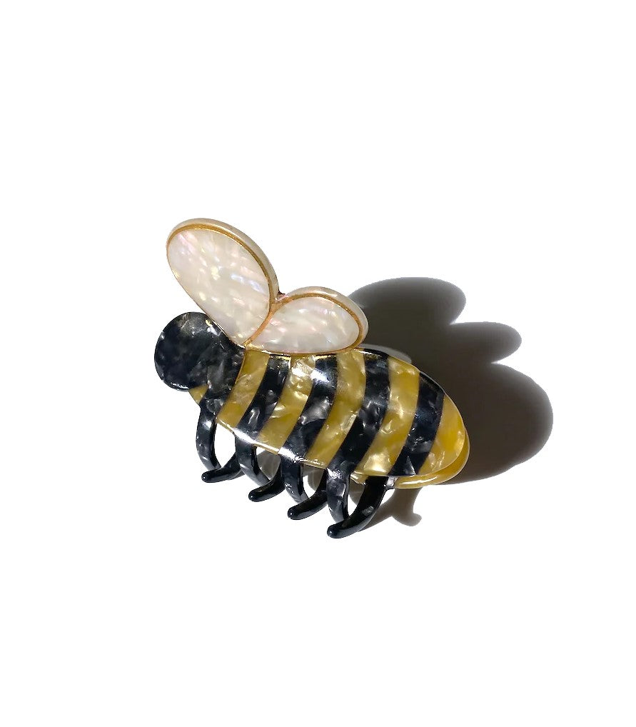 You'll be super buzz-y accepting compliments with this bumble bee hair clip. It is double sided for a perfect look from every angle. Unlike most plastic accessories, these small-batch styles are made from a biodegradable wood pulp acetate, making these clips both beautiful and kind to the environment! Size: 3" x 2".