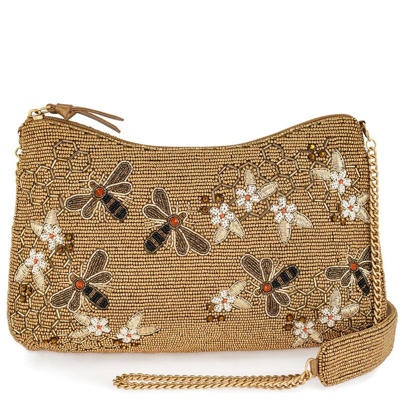 This crossbody handbag is a buzzing beauty, with golden beads woven into a honeycomb pattern and embellished with beaded bees and flowers. Its roomy interior, padded shoulder strap and secure zipper make it the perfect companion for any occasion. Dimensions: 11 x 2 x 6.5". Handmade.
