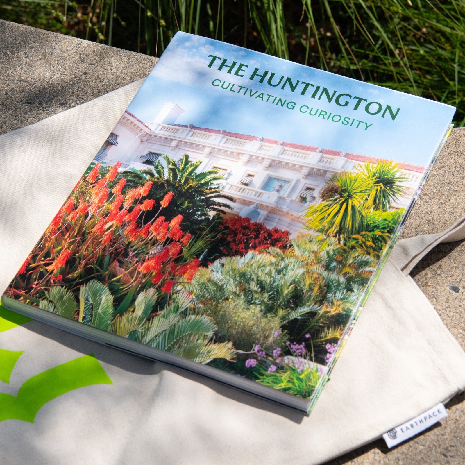 Cover of 'The Huntington' with a garden scene and building in the background