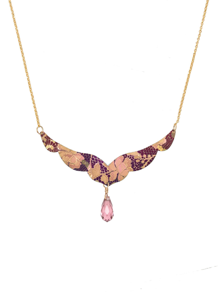 Add a floral finishing touch to your outfit with this perfectly pretty necklace. It features a 'V' shaped pendant with a scalloped edge and is etched with a floral design in purple and pink on a rose gold colored base. Niobium. Gold plated chain. Glass bead. Adjustable chain - 18-20”. Pendant - 1.5" × 2.25”.