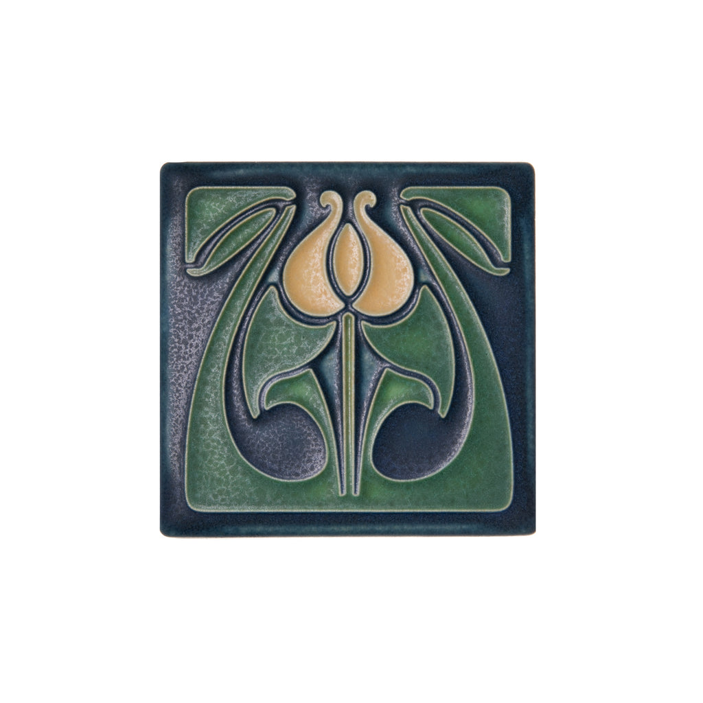 This Motawi Tileworks tile depicts a spring tulip, with butter-colored petals lush green leaves and an indigo blue base, rendered in a classic Arts & Crafts style. This high-quality art tile would make a great accent in a renovation project, or simply display on a tile stand or hang on a wall. Size: 3 7/8” x 3 7/8”.