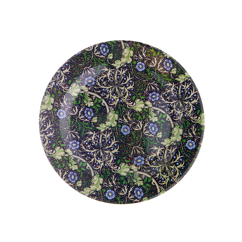 This tin plate features the iconic seaweed pattern which was first designed as a wallpaper for Morris & Co by designer John Henry Dearle in 1890. William Morris (1834-1896) was an artist and philosopher and is considered one of the most outstanding and influential designers of the Arts & Crafts movement. Diameter: 10".