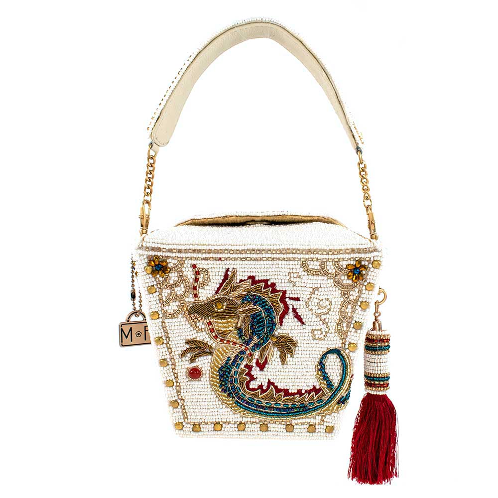 Inspired by the iconic Chinese food takeout container, this unique accessory features an intricate embellished dragon motif with elegant, embroidered detailing, making it a captivating blend of ancient traditions and modern fashion. Dimensions: 6" x 4.75" x 5".  Strap length 15".