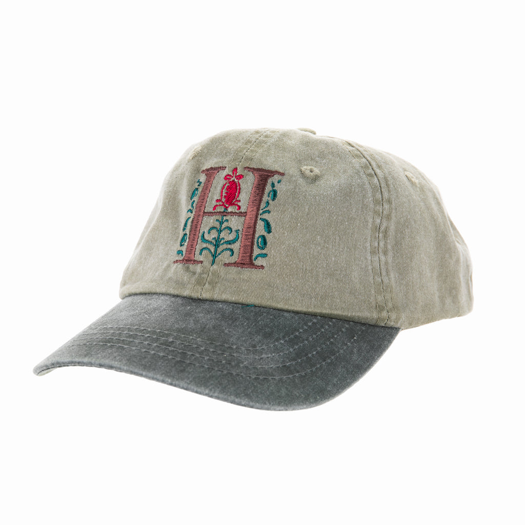 A Huntington cap with our signature "H" logo embroidered in multi-colors on the front and a surprise squirrel on the back! Olive hat with green bill One size fits most Exclusive to the Huntington Store