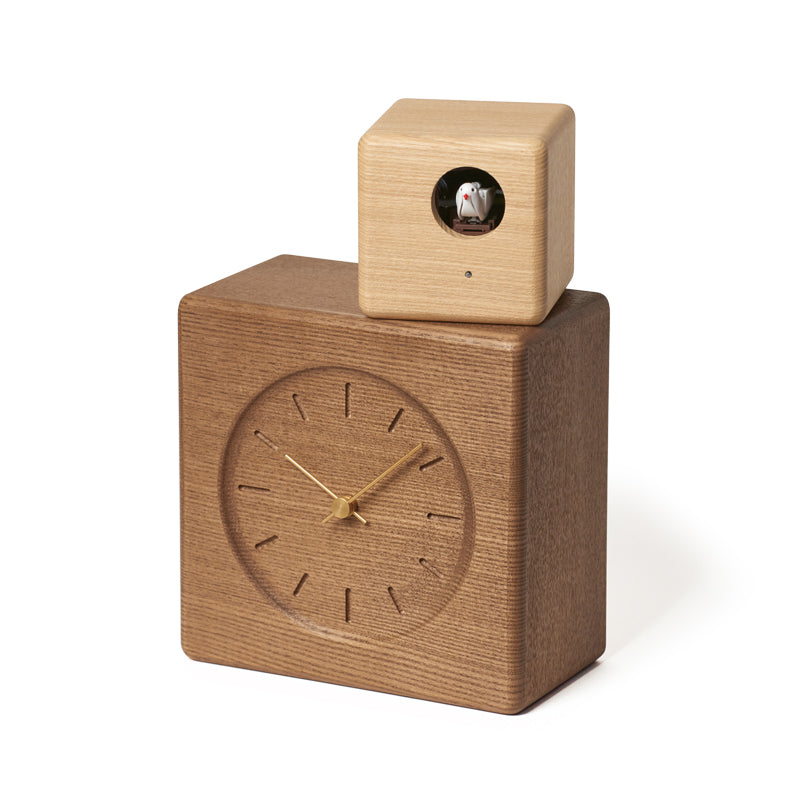 Designed by Gabriel Tan Inspired by postmodern architecture, this cuckoo clock consists of two stacked volumes, made from solid Japanese ash wood. The larger cube contains the clock body and a smaller cube houses the cuckoo, which can be rotated to face different directions.. 7.3 W x 10.8 H x 4.1 D inches. 