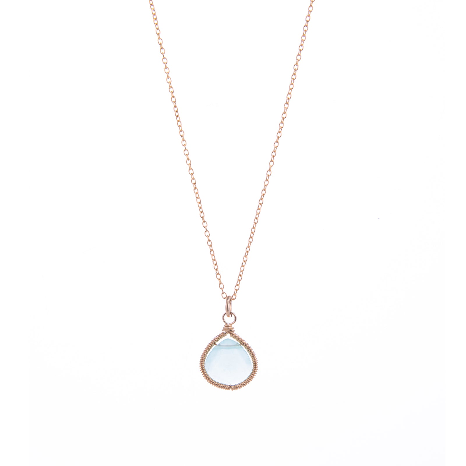 A rose gold necklace with a teardrop-shaped light blue gemstone wrapped in textured rose gold wire, shown against a plain white backgroun