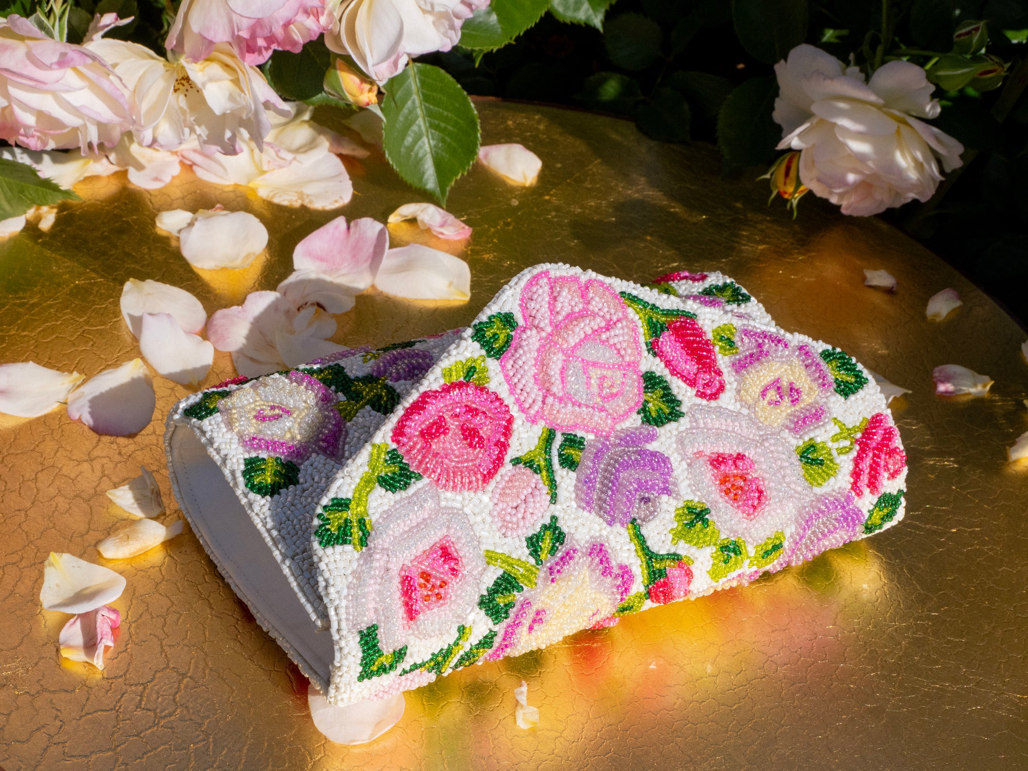 Designed exclusively for The Huntington Store, our iconic Rose Garden inspired this opulently hand-beaded purse. The purse features colorful blooms in shades of pink, lemon, and lilac, accented by verdant green leaves on an ivory base. Our Huntington’s 100th two-tone rose makes a star appearance.