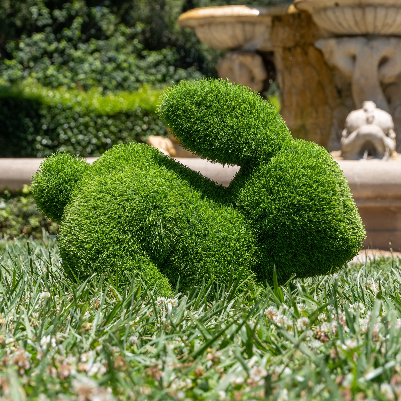 Green rabbit-shaped topiary on a white background