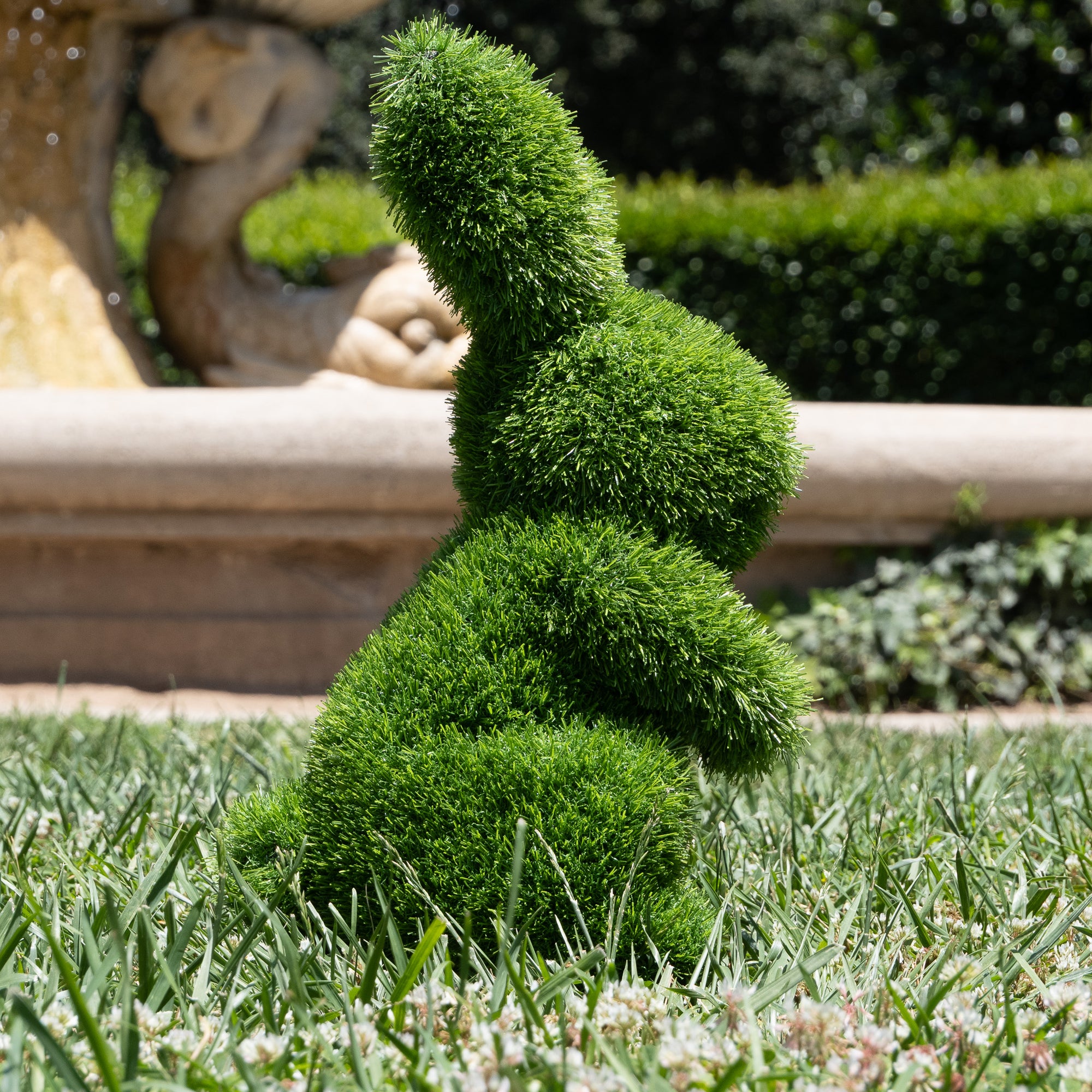 Green rabbit-shaped decorative item on a white background