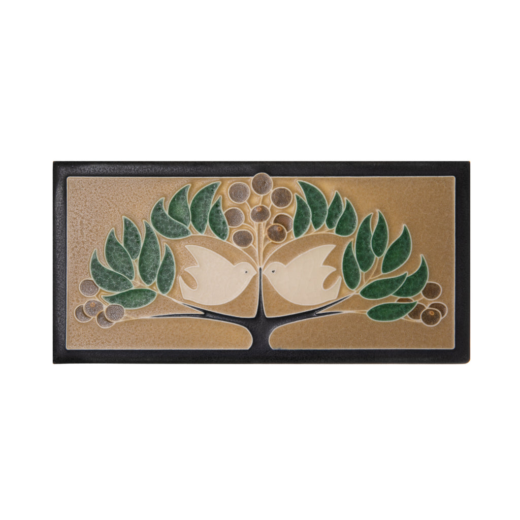 This decorative high-end lovebird's ceramic tile is handcrafted in the style of the Arts and Crafts movement by Motawi Tileworks. This image is inspired by early 20th-century English architect Mackay Hugh Baillie Scott who designed needlepoint patterns for his wife, Florence, to stitch. 3 13/16 x 7 13/16". 