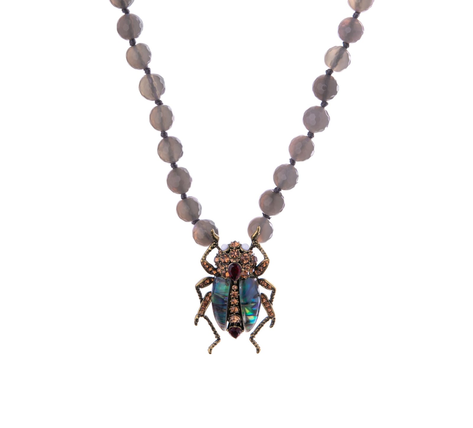 With antique gold detailing for a vintage feel, you will be turning heads with this Jewelled Beetle Statement Necklace. The resin stones and hand set crystals make up this stunningly iridescent beetle. Materials: Swarovski Crystals, Agate Beads Dimensions: Approx. 18" Length, 1.4" x 2" - Pendant Magnetic Clasp
