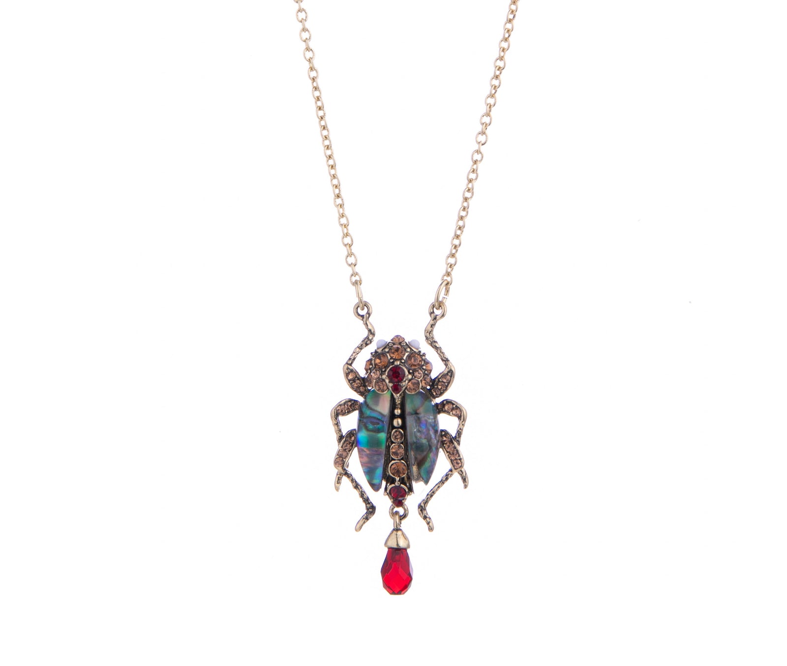 This jewel-encrusted bug pendant is the perfect accent to your outfit and one of our best-sellers. Amber and ruby crystals adorn the body and head, and black iridescent mother of pearl makes up the wings. Material: Gold-plated Brass, Acrylic Resin Length 15.75" Pendant 1.5" x 0.6" Lobster Claw fastening
