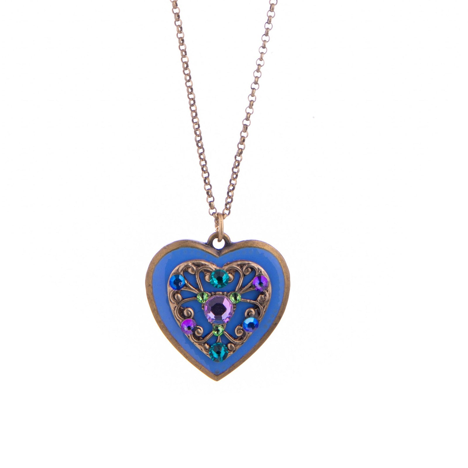 A heart-shaped pendant necklace with a blue enamel background and an ornate filigree center in gold, purple, and green, suspended from a delicate rose gold chain against a white background.