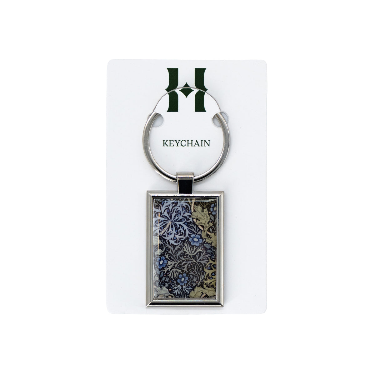 Keychain with floral design on a white card with 'H' logo