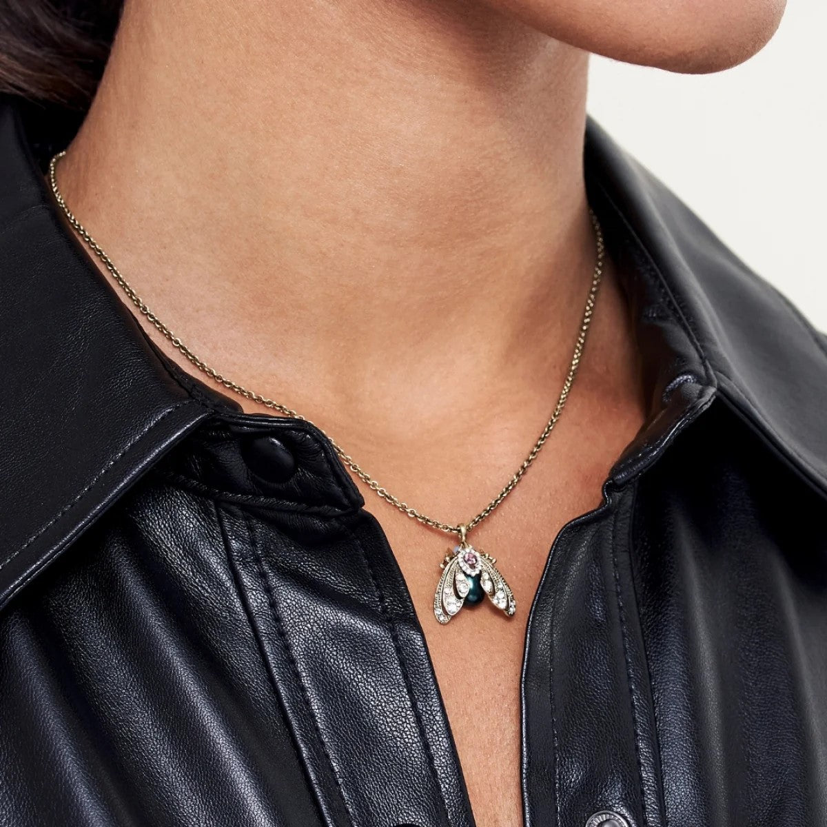 This significantly sparkly Jeweled Moth Pendant Necklace has an antique finish, crystal detail, and synthetic pearls. Great for showing off some major sparkle. Material: 18 ct. Gold-plated Brass, Synthetic Pearl Dimensions: Approx. 16" Chain Length with 2" Extender, Pendant - 0.7" x 0.7" Lobster claw clasp