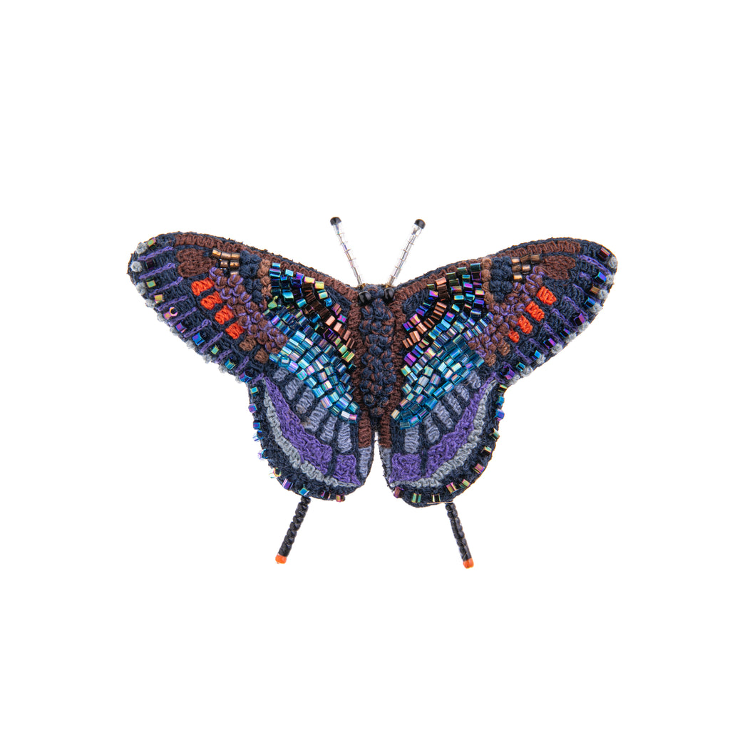 The red spotted purple butterfly is elusive although it enjoys basking in the sun. Add its rare beauty to your outfits with this intricately hand-beaded pin. 