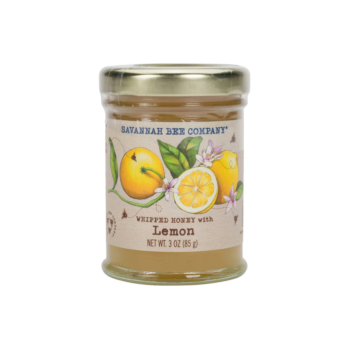 Jar of lemon-flavored whipped honey on a white background