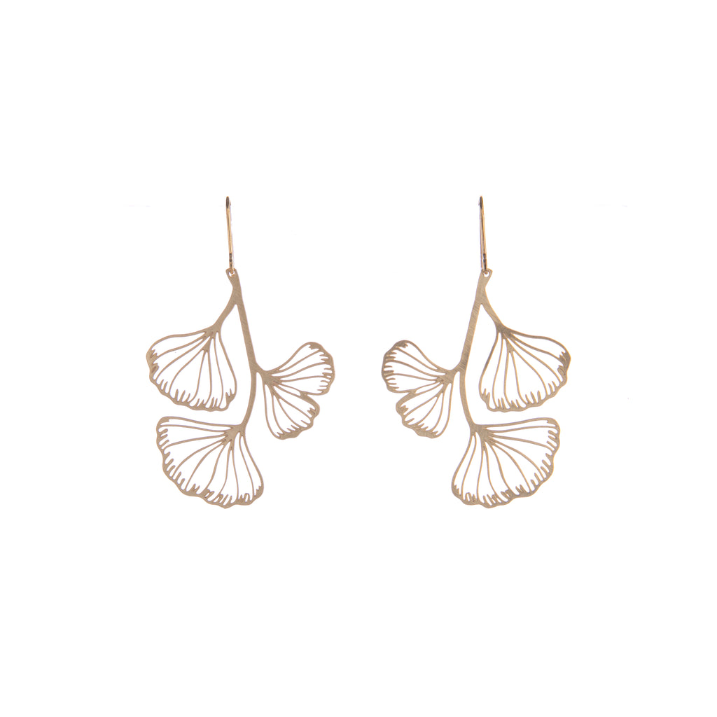 The stunning fan-shaped ginkgo leaves are celebrated in these gold-plated dangle earrings. These ginkgo earrings would look stunning as an addition to any outfit. Pair with your other gold jewelry or wear on their own for the ultimate ginkgo glamour. Dimensions: 2" L x 1.25" W Material: Gold-plated brass 