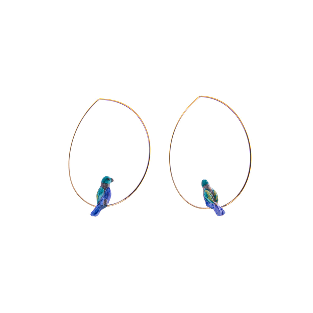 These hoop earrings feature a tanager perched on a fine gold hoop. Made from durable, lightweight porcelain and 24K gold plated brass. The porcelain elements are individually painted by hand, making each pair unique. Lead and nickel-free Material: Porcelain & 24k gold plated brass Dimensions: Approx. 1.5" Diameter 