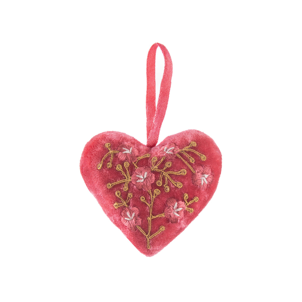 This beautifully luxurious 'Misha' heart ornament is made from coral pink 100% silk velvet which is then sumptuously padded and embroidered with deep rose pink flowers. It is finished off with a silk-satin ribbon loop for easy hanging. Created by Anke Drechsel, a German textile designer. Dimensions: 3.25" x 2.5".