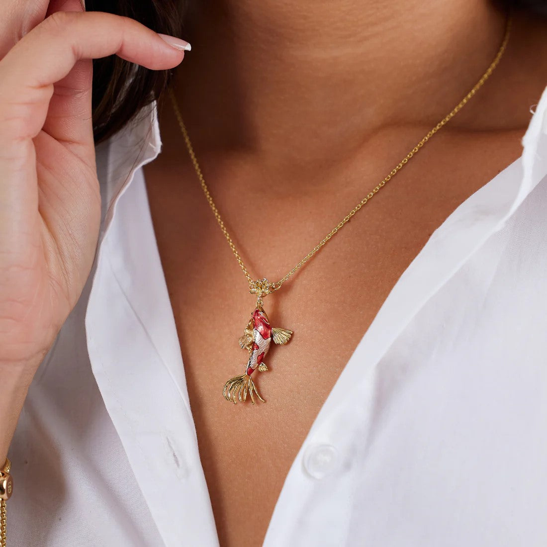 In Japan, koi fish have come to be symbols of love and friendship. With a golden lily pad, this koi fish necklace is perfect to wear to an event. The gold plating and chain and vibrant red enamel makes the necklace incredibly elegant. Dimensions: Approx. 15.7" Chain Length, Material: Gold-plated Brass, Enamel 