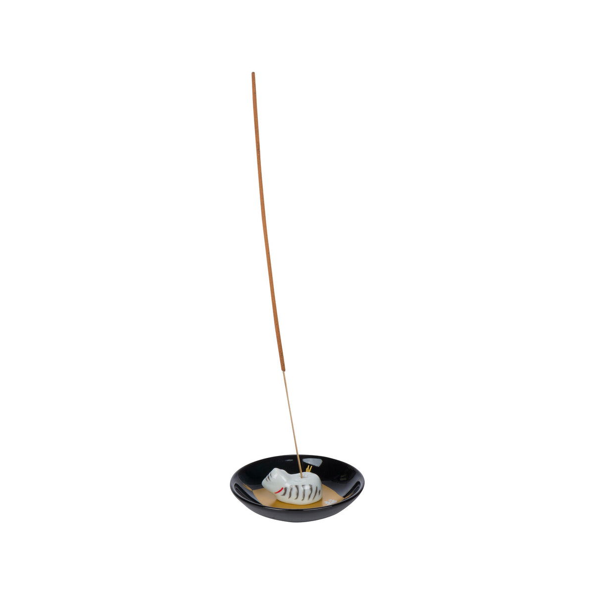 Incense stick in a black holder with a small cat figurine on a white background