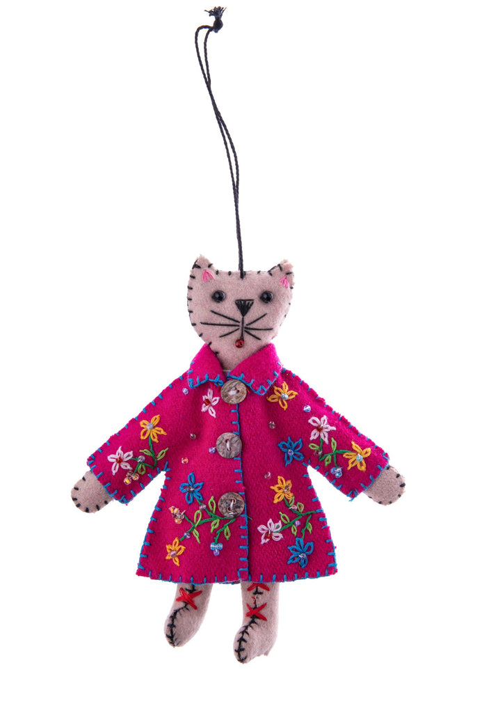 What could be cuter than a cat in a coat? This cat in a pink coat ornament is decorated with flowers for an adorable botanical detail. With additional beads and buttons, this stylish feline will look adorable hung up anywhere you decide. Dimensions: Approx. 5.5" L x 4.5" W Material: Felt, Beads