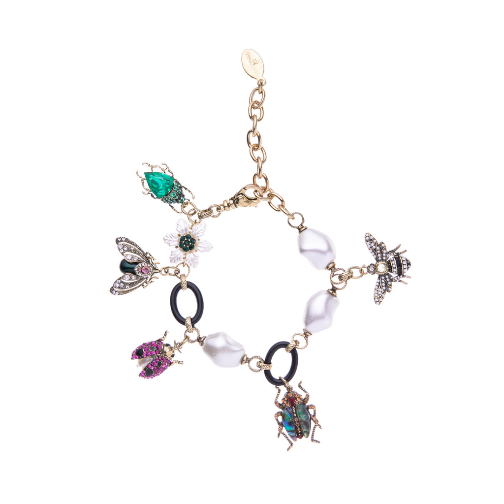 Celebrate your love of bugs with this bug charm bracelet. With its various charms, including a mother of pearl flower, bugs, and black oval rings, this bracelet will add whimsy to your jewelry collection. Dimensions: Chain Extender - Approx. 2", Chain Length - Approx. 7" Material: Gold-Plated Brass, Enamel, Acrylic