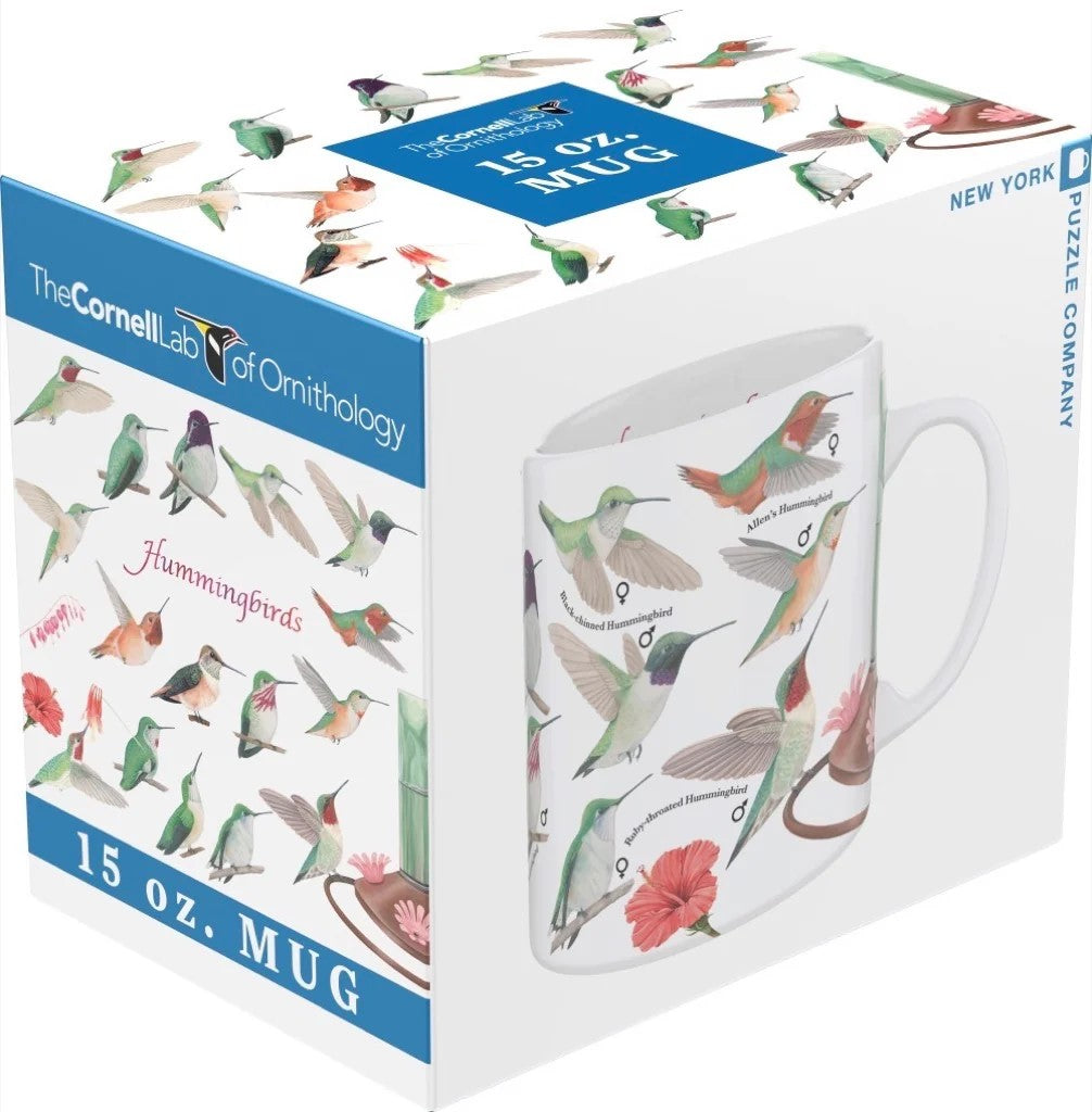 A white ceramic mug with various illustrations of hummingbirds and a flower design.