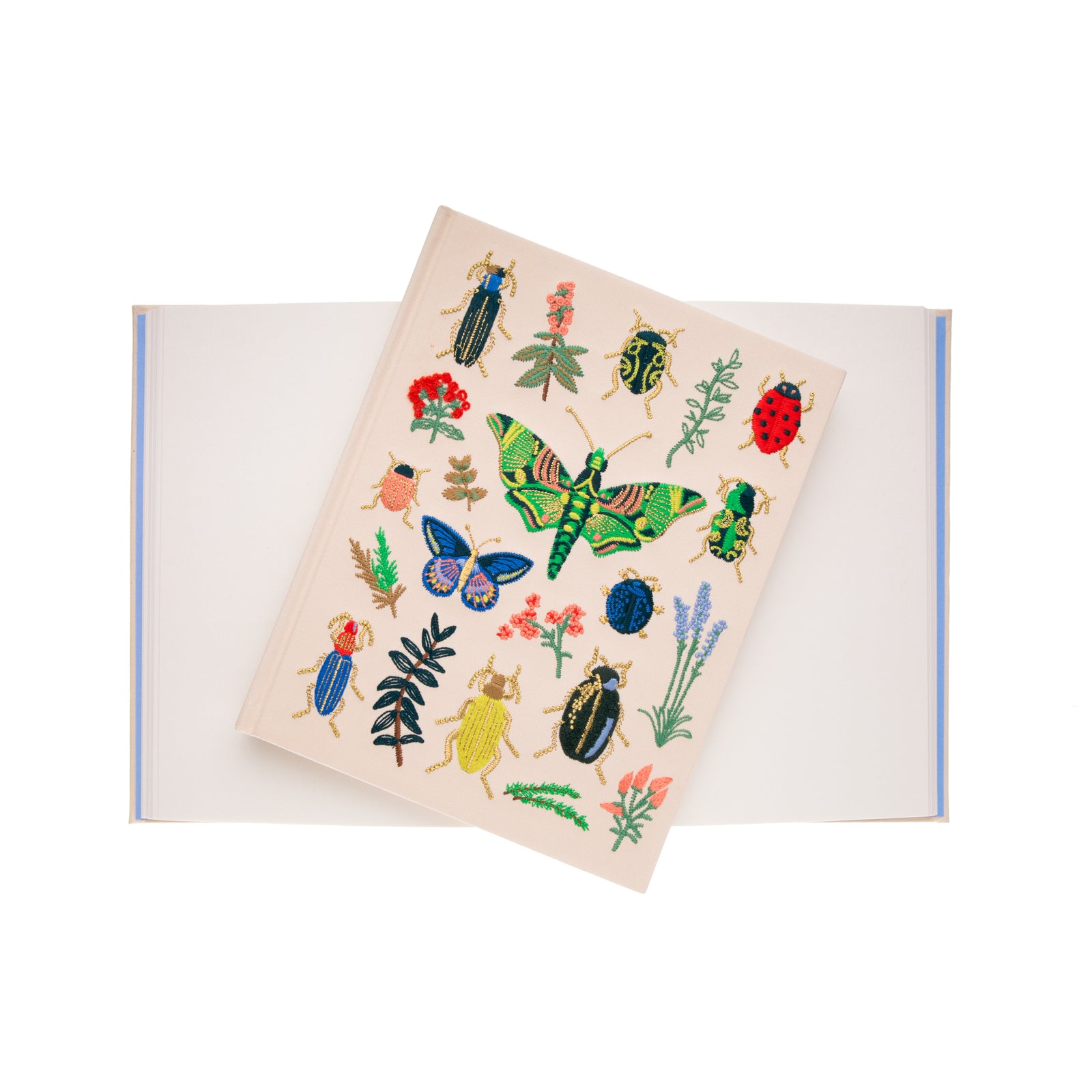 This embroidered sketchbook is a large, hardcover journal with 108 unlined pages of thick paper perfect for sketching, drawing, and journaling. The cover is wrapped in cream book cloth and embroidered with beetles and bugs with metallic gold accents. Attached grosgrain ribbon bookmark. 10.25" L × 8.25".