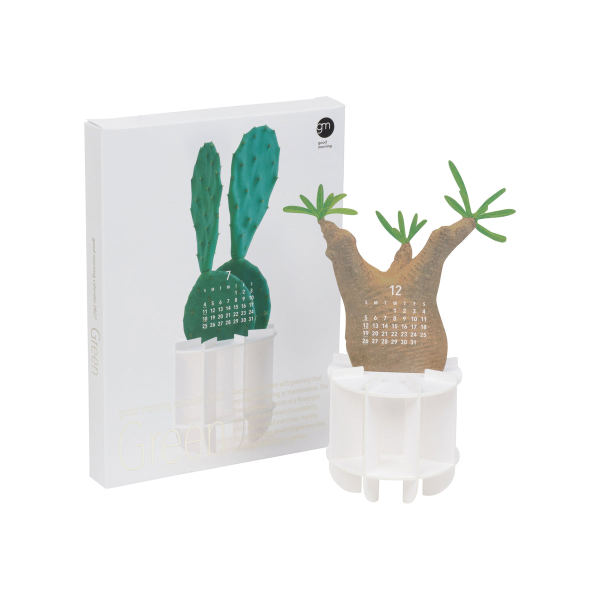 A 3D paper calendar featuring a cactus design, shown next to its white product packaging box. The calendar is made of brown and green paper, standing in a white plastic pot, with the calendar page showing the number 12.