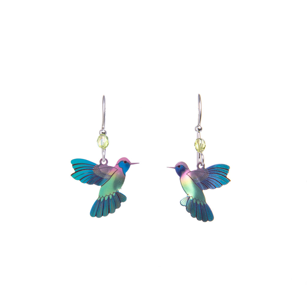 Sweet, vibrant, and joyful, these earrings embrace the essence of a hummingbird’s magic and grace. Artfully detailed and hand-colored with exhilarating hues, these dainty hummingbirds seem to flit about on the delicate ear wires.  Materials: niobium with sterling silver ear wires. Dimensions: 1.25" x 3".