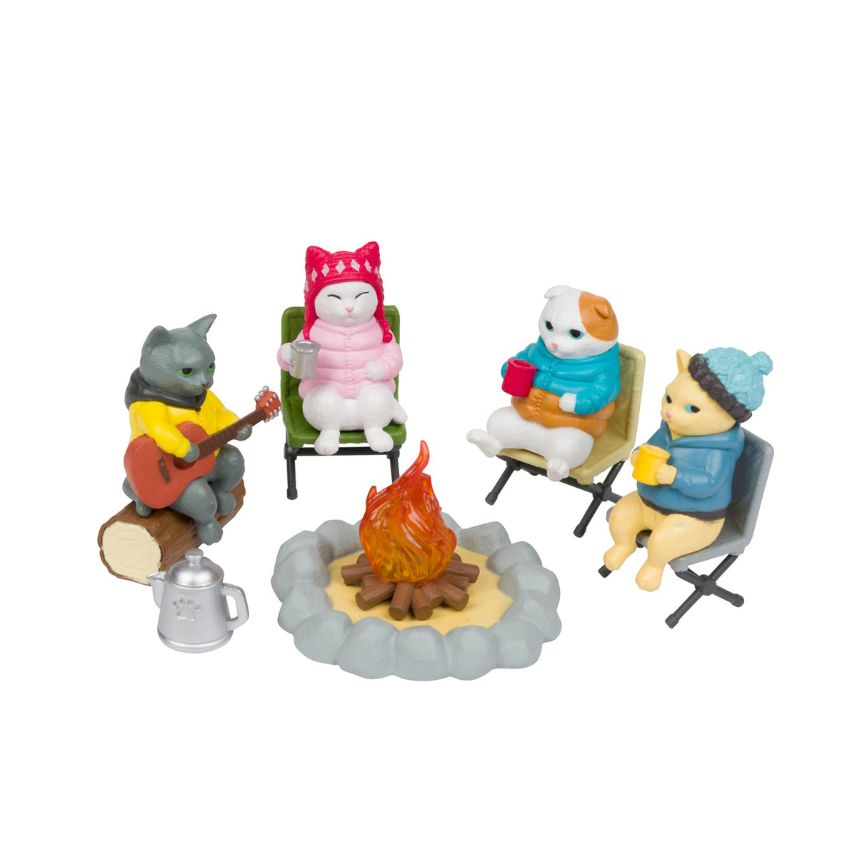 Four small animal figurines sitting around a campfire on a white background. The figures include a gray cat playing an orange guitar, a white cat in a pink outfit, a white and brown dog in a blue sweater holding a red mug, and a yellow cat wearing a blue beanie holding a yellow mug.