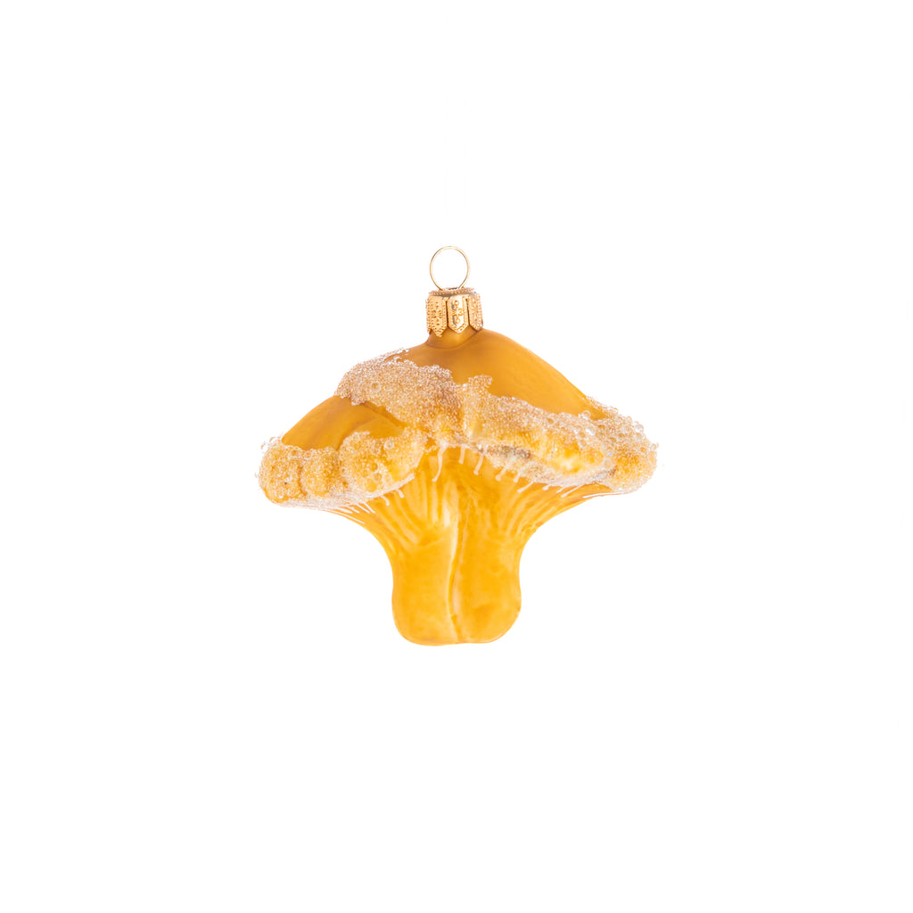 Add a little woodland wonder to your home and holiday decor with this adorable yellow mushroom. Decorated with glitter and coated in frosting, this Enchanted Yellow Mushroom ornament is a delightful addition from the forest to add a mystical touch to your home. Hand painted glass ornament Dimensions: 2.75" x 3"