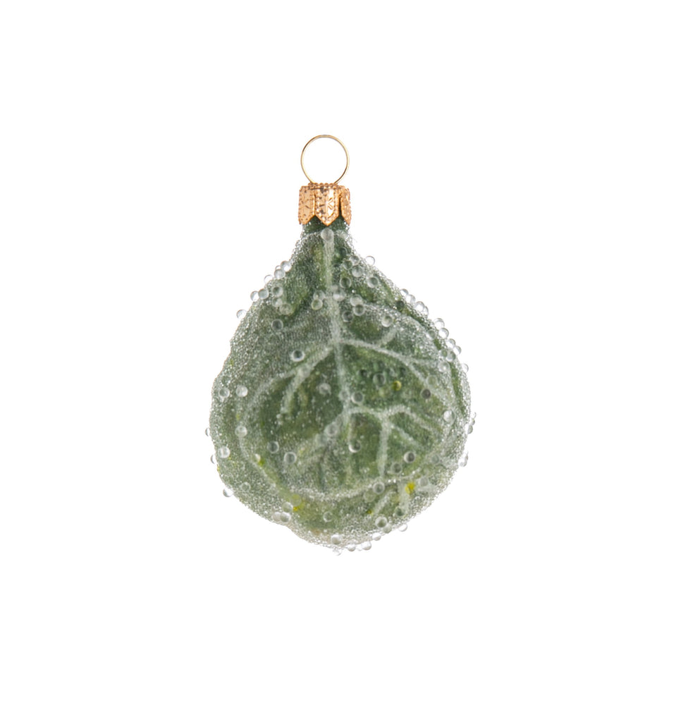 Whether you love them or hate them, there's no denying that the humble Brussels sprout is a holiday vegetable tradition. Celebrate it with this fun and festive glass ornament, which gives the sprout an enchanting makeover with a frosted, sparkling coat which is sure to look a real treat on your tree!  3" x 2 1/4".