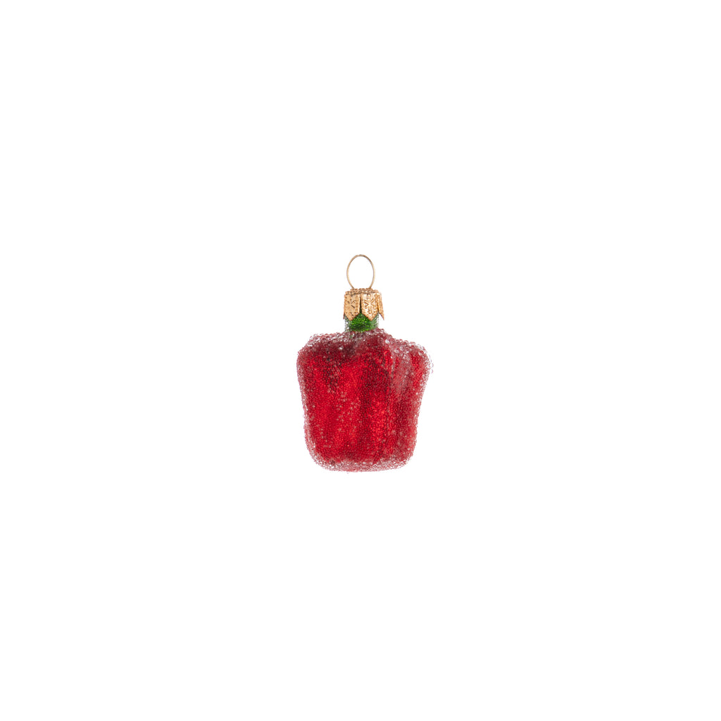 The sweetest of all the bell peppers is of course the red one. Decorated and coated with frosting, this Enchanted Red Bell Pepper ornament looks fresh off the plant and is a great addition to your home and holiday decor. Hand painted glass ornament Dimensions: 2" x 1.25"