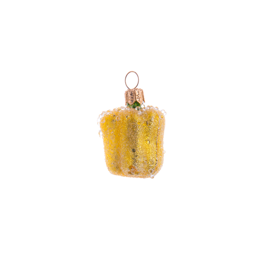 Celebrate the versatility of a yellow bell pepper! Decorated and coated with frosting, this Enchanted Yellow Bell Pepper ornament looks fresh off the plant and is a great addition to your home and holiday decor. Hand painted glass ornament Dimensions: 2" x 1.25"