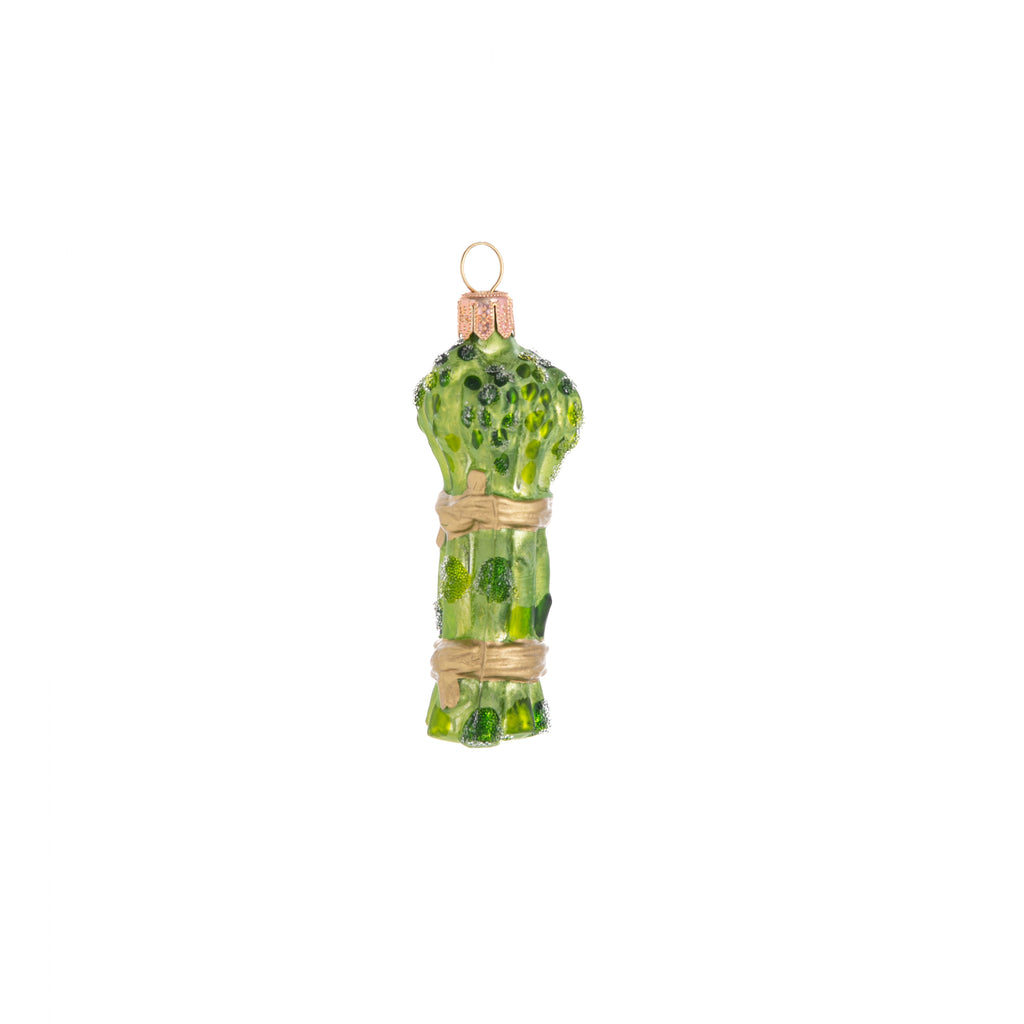 Asparagus has never looked so elegant! This bountiful bunch is tied with golden ribbons and sprinkled with festive frosting. The Enchanted Asparagus ornament is smaller than its counterpart but still an adorable addition to your home and holiday decor. Hand-decorated glass ornament Dimensions: 3.5" x 1.25"