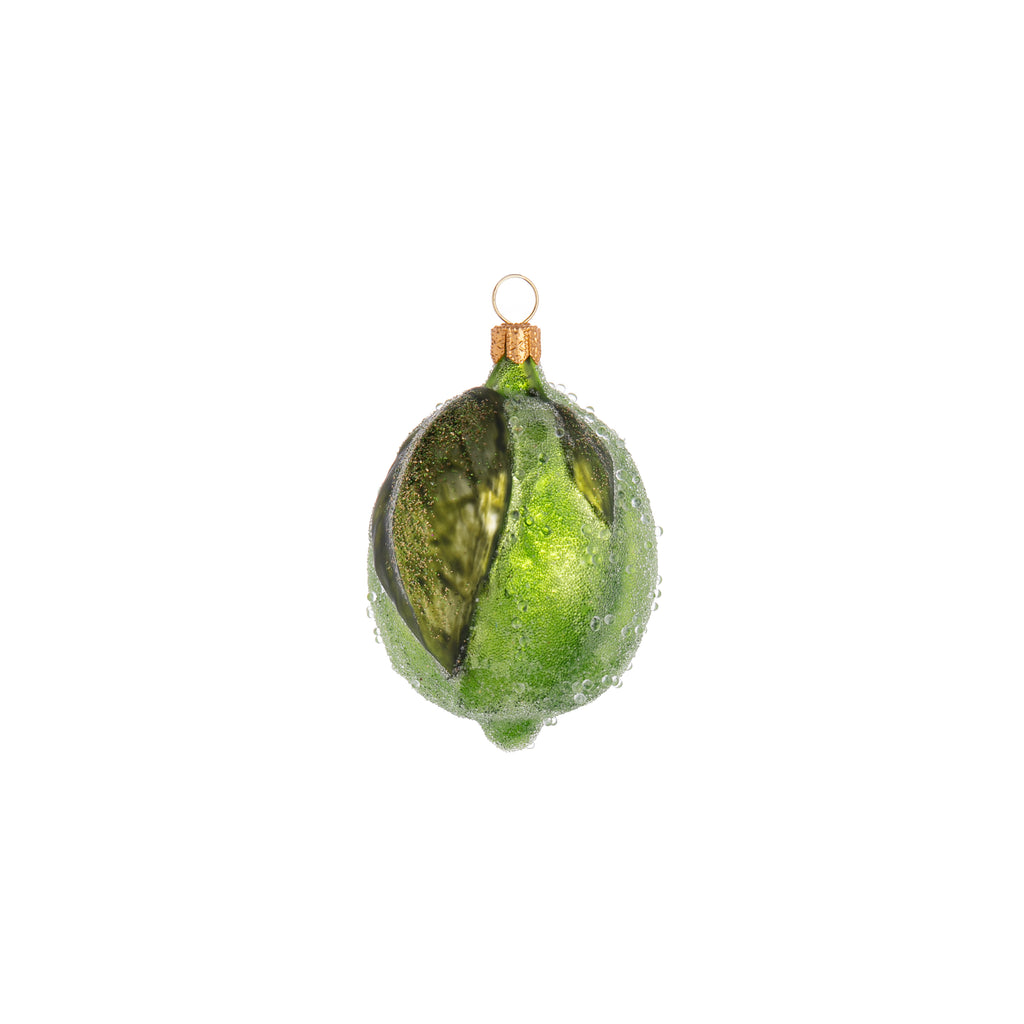 Essential for homemade guacamole, fabulous in many cocktails, the humble lime has become a pantry staple. Celebrate this tangy, citrussy wonder with this lovely lime glass ornament. It is handmade, and hand finished with glitter and faux frost giving it an enchanted appearance.  Dimensions: 3.25" x 2.25".