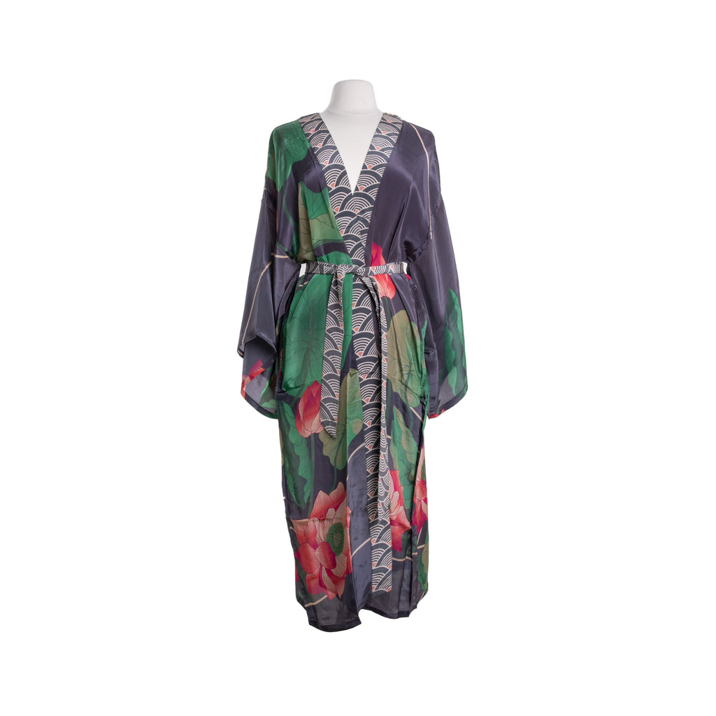 This stunning short-length kimono jacket features a large, majestic crane standing amid oversized greenery at sunset. The kimono features a flattering back neckline, side slits that allow for movement, and wide sleeves—all of which make it a breeze to wear casually or dress up for a formal event. One size fits most.