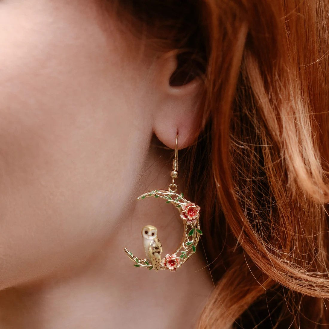 This adorable barn owl perches on a 18ct gold-plated crescent moon adorned with enamel flowers. Even though this owl enjoys its nocturnal activities, these earrings are enchanting enough for day or night. Material: 18ct Gold-plated Brass, Enamel Dimensions: Approx. 1" W x 2" L Fish hook fastening