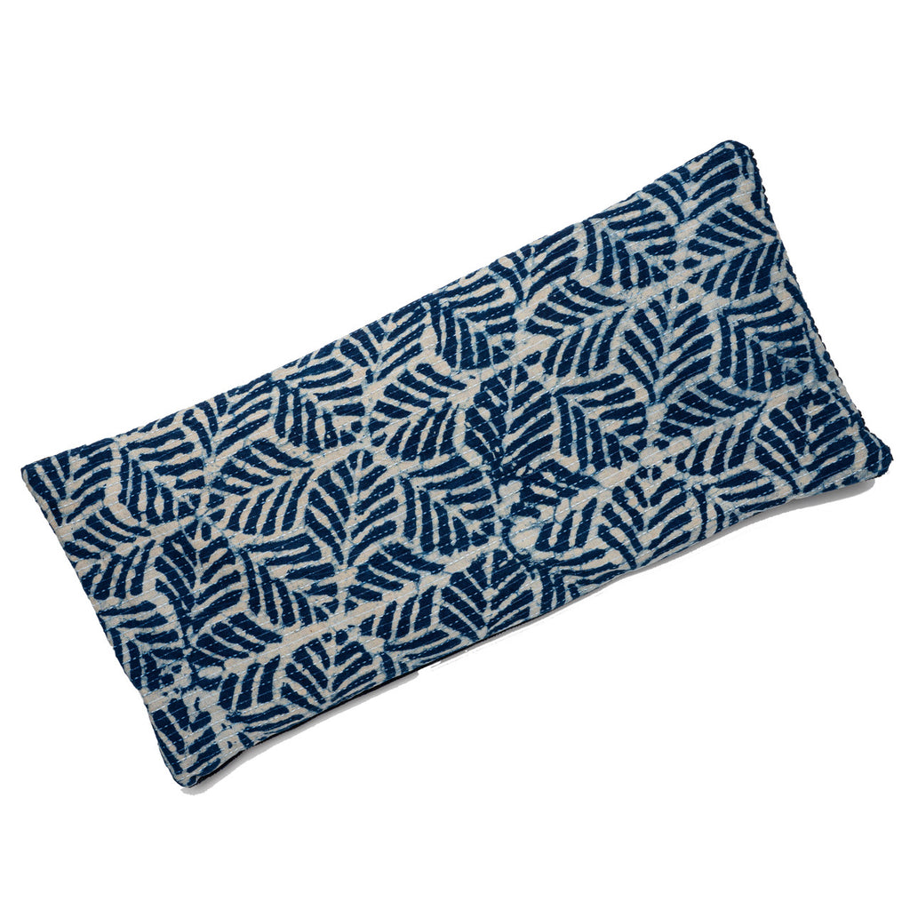 This comforting spa pillow is covered with hand-printed indigo cotton imported from India and backed with a cozy cotton corduroy. Use anywhere on the body to relieve tension and ease muscles aches. Filled with French lavender and hearty flax seeds for a soothing scent and relaxing, weighted feel. Handmade.  7" x 15".