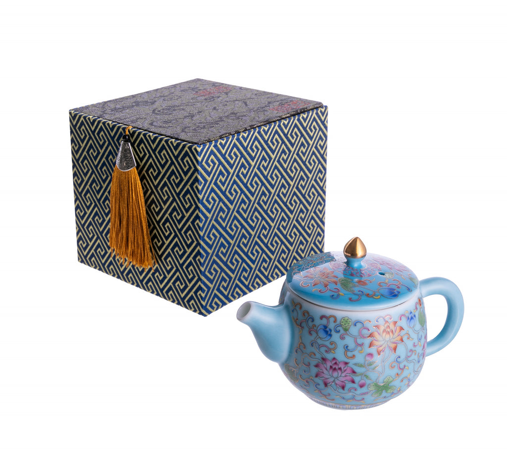 This delightful ceramic teapot is decorated with colorful waterlilies and houses a gorgeously fragranced, wooden wick candle inside, with notes of fresh water and grapefruit. The teapot can be used as a pretty ornament or trinket dish after the candle has been used. Candle: 5" x 3", Keepsake box dimensions: 5" x 5".