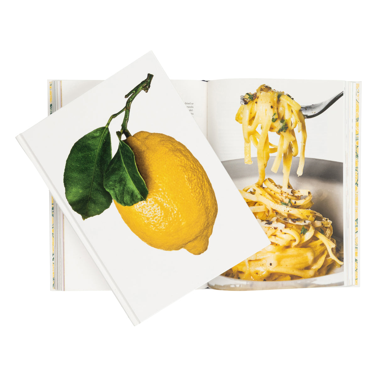 An open cookbook or recipe book on a white background, with one page showing a bright yellow lemon with green leaves and another page showing a fork lifting pasta.